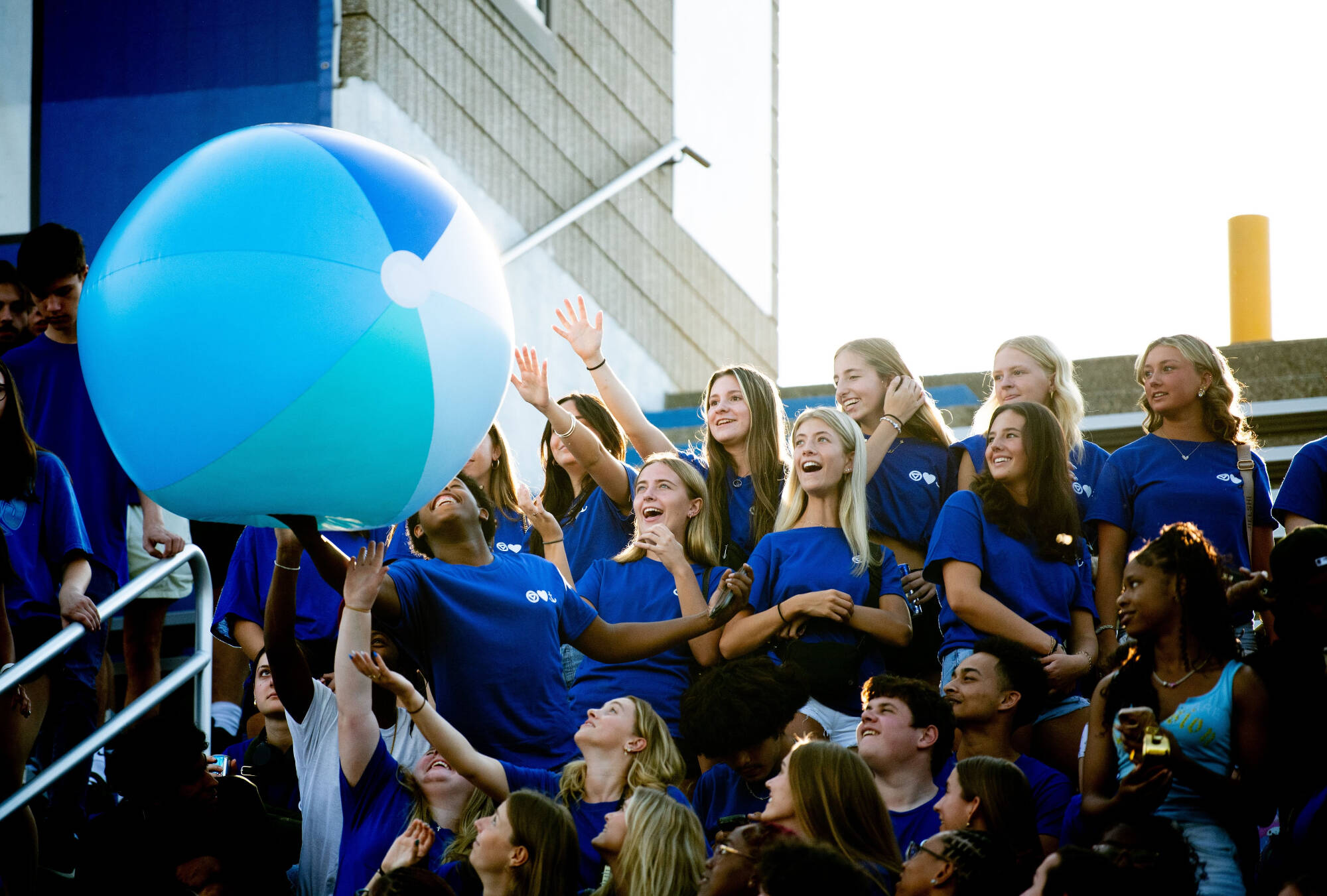 Students passing around a big beach ball at Lubbers Stadium